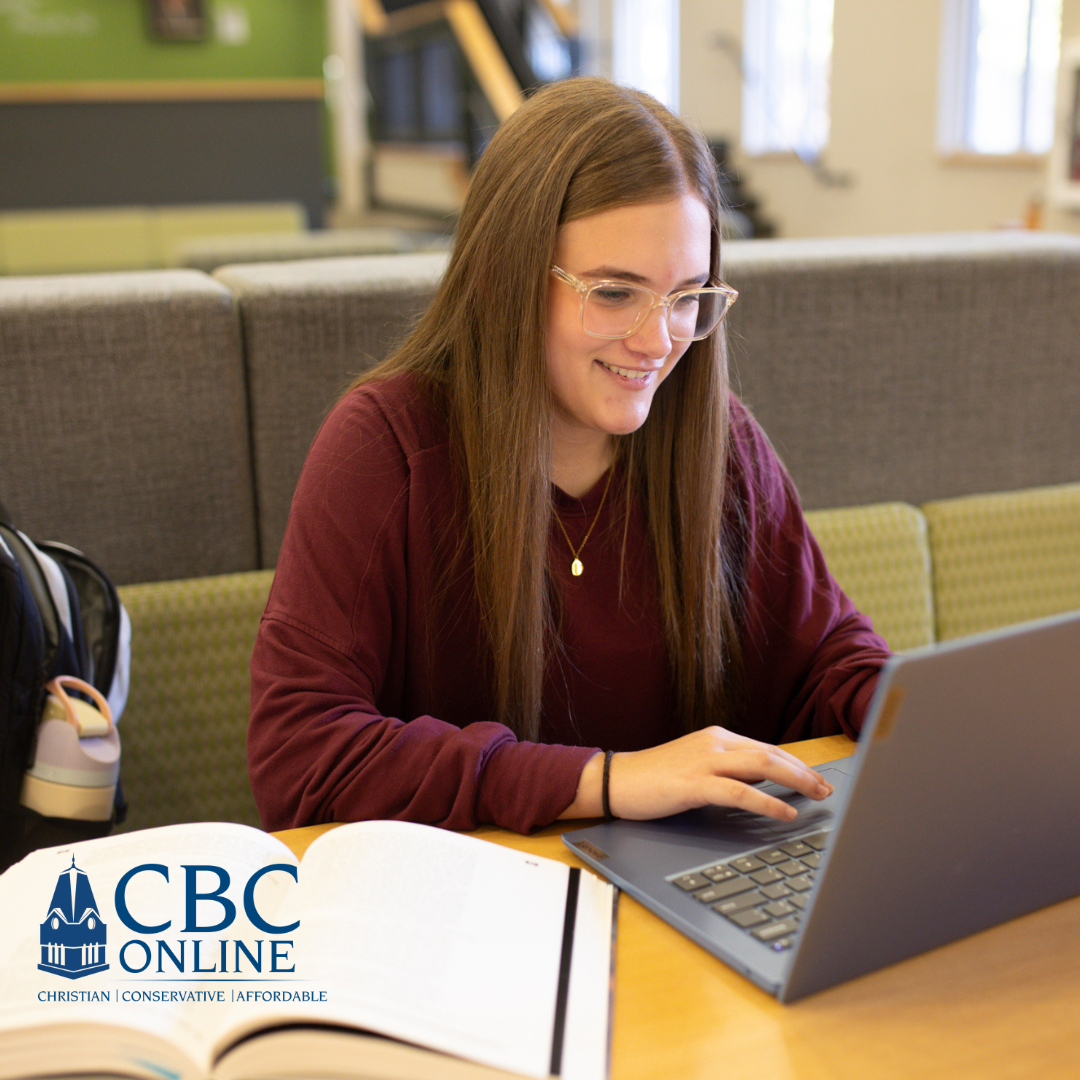 A young woman with long brown hair and glasses smiles while working on a laptop in a study area. An open book and backpack are on the table. The CBC Online logo appears in the bottom left corner.